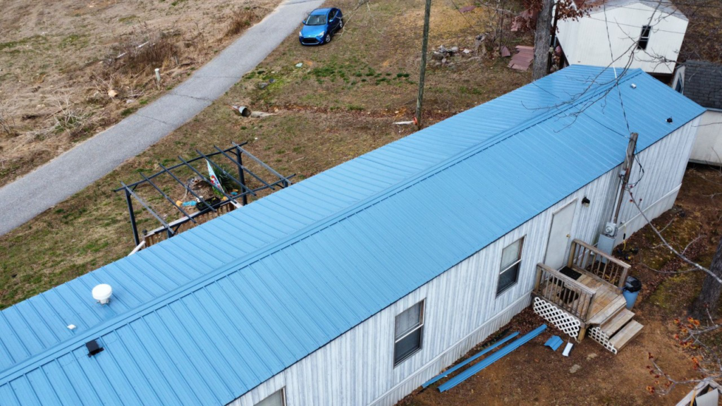 A blue metal roof installed on a residential property by Gator Metal Roofing.